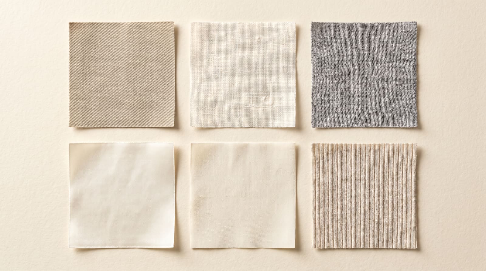 Six fabric swatches in neutral tones, including a twill, a linen, a grey knit, a smooth sateen and a rib knit